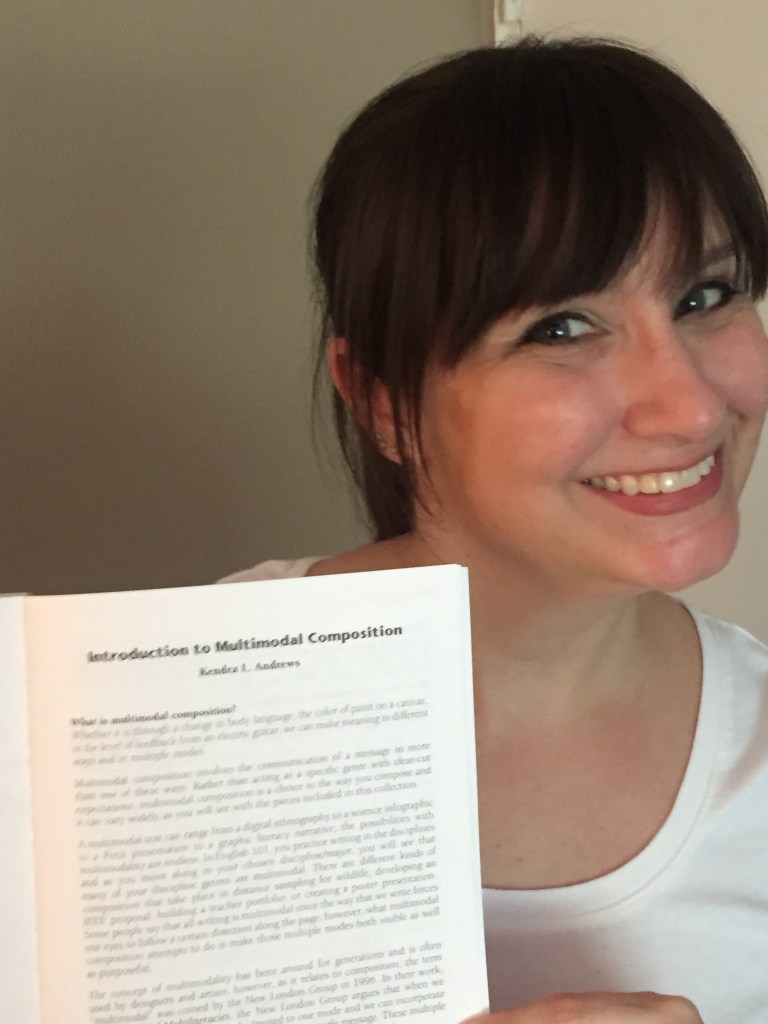 Kendra holding her first publication on Multimodal Composition